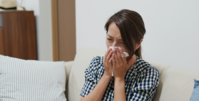 Woman suffer from influenza, sneeze at home