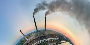 Aerial view from high altitude of little planet earth with coal power plant high pipes