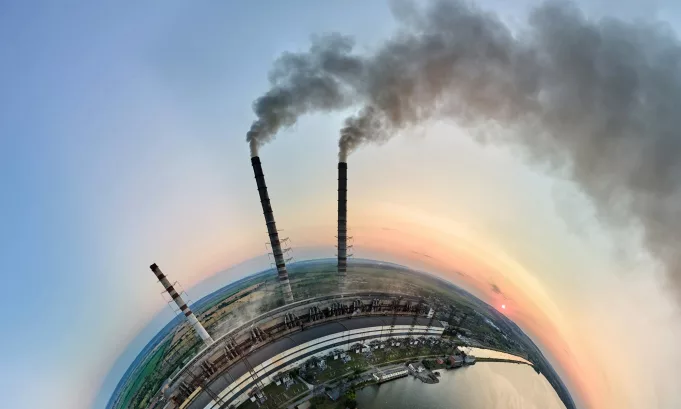 Aerial view from high altitude of little planet earth with coal power plant high pipes