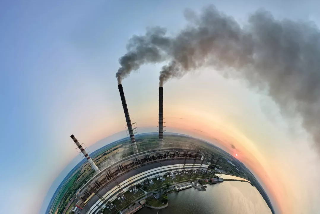 Aerial view from high altitude of little planet earth with coal power plant high pipes