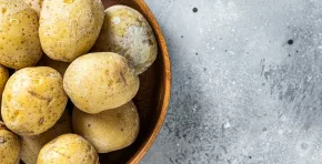 Canarian boiled potatoes papas arrugadas. Gray background. Top view