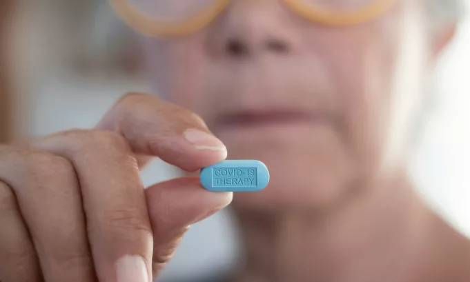 Female doctor holding the pill tablet for the fight against covid-19 coronavirus